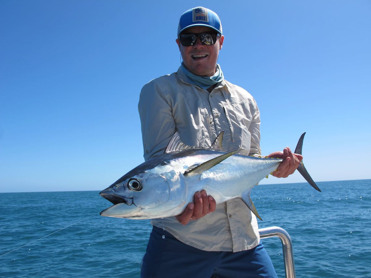 Olli-Mikael Vaittinen, founder of Fishare, holding a yellowfin tuna boatside