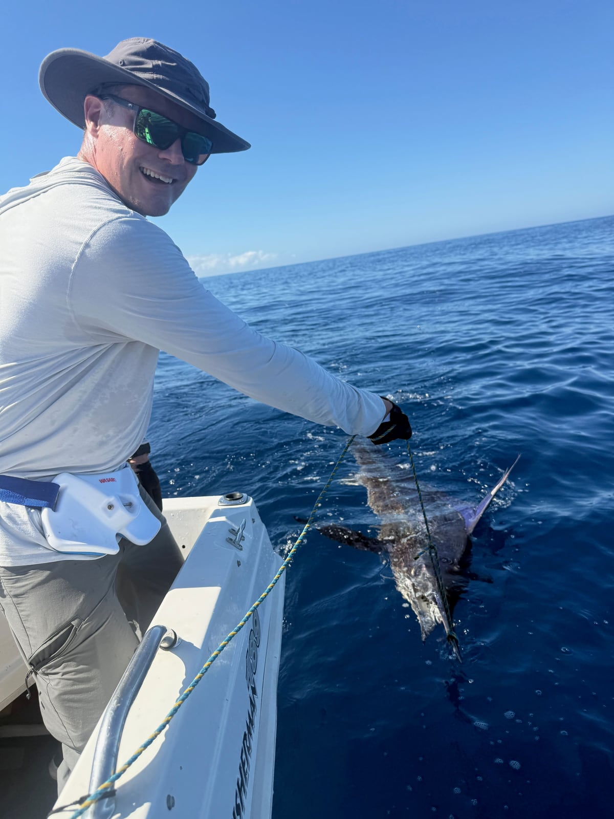 Olli-Mikael Vaittinen releasing a striped marlin boatside off the Australian coast